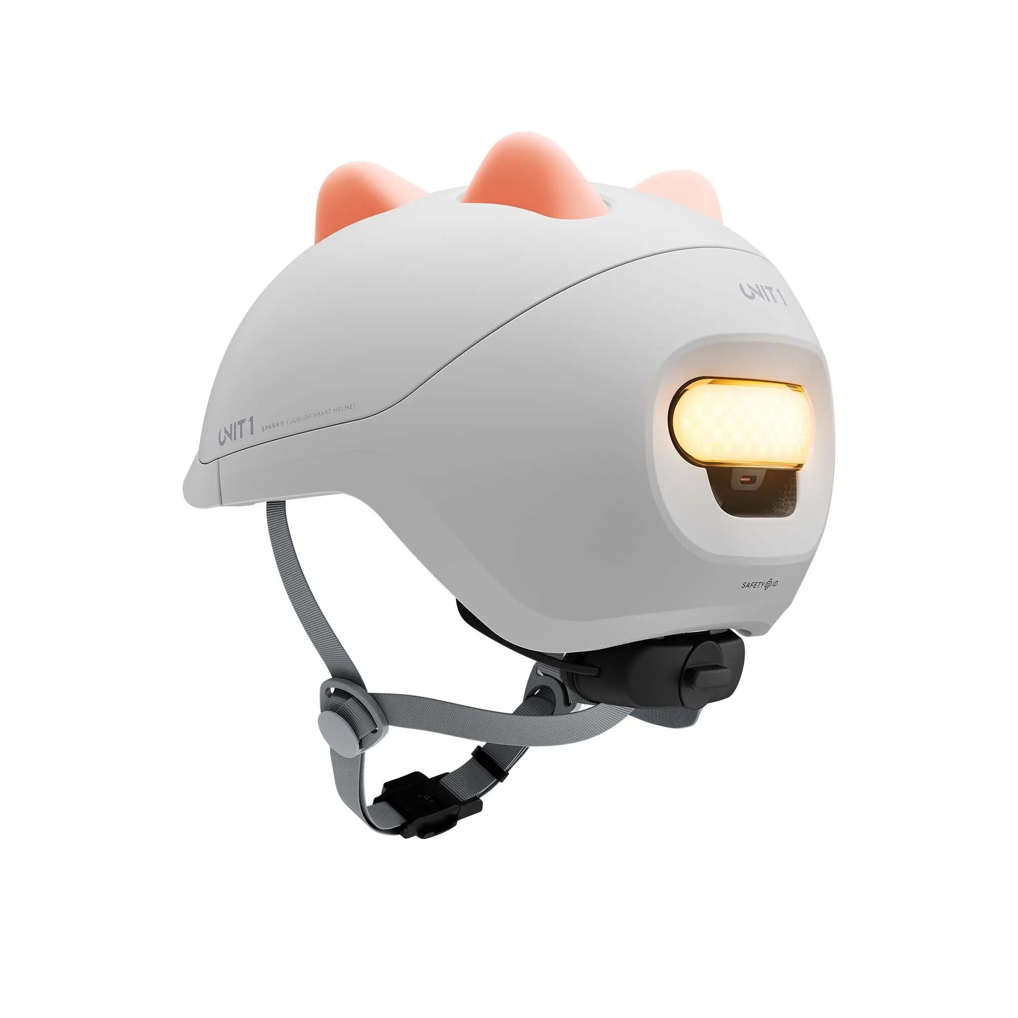 UNIT 1 Dino silicone inserts in tangerine orange, fitted to a SPARKY kids' helmet, three-quarter rear view
