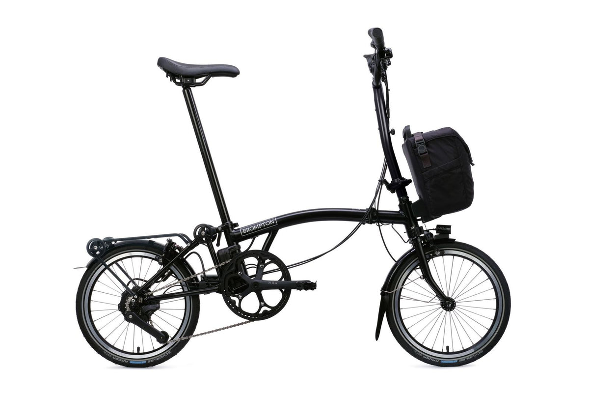 Brompton Electric C Line in matt black — full side view with front bag