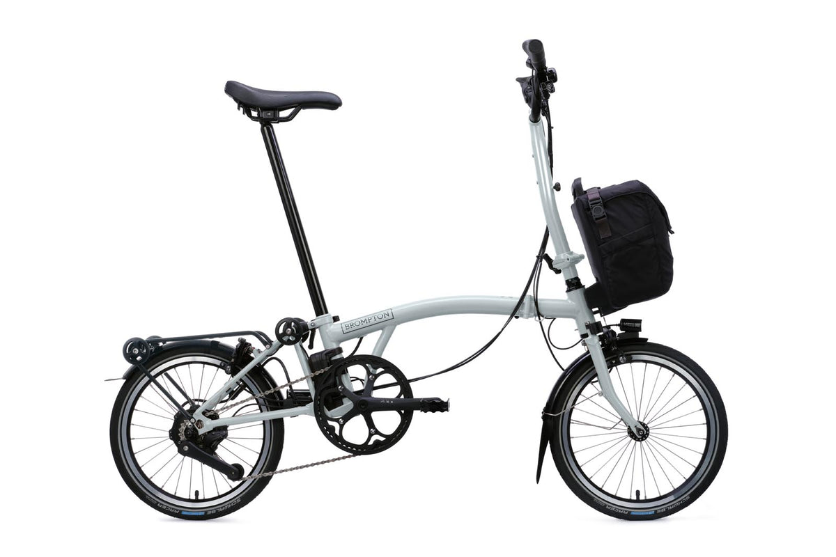 Brompton Electric C Line in lunar ice metallic — full side view with front bag