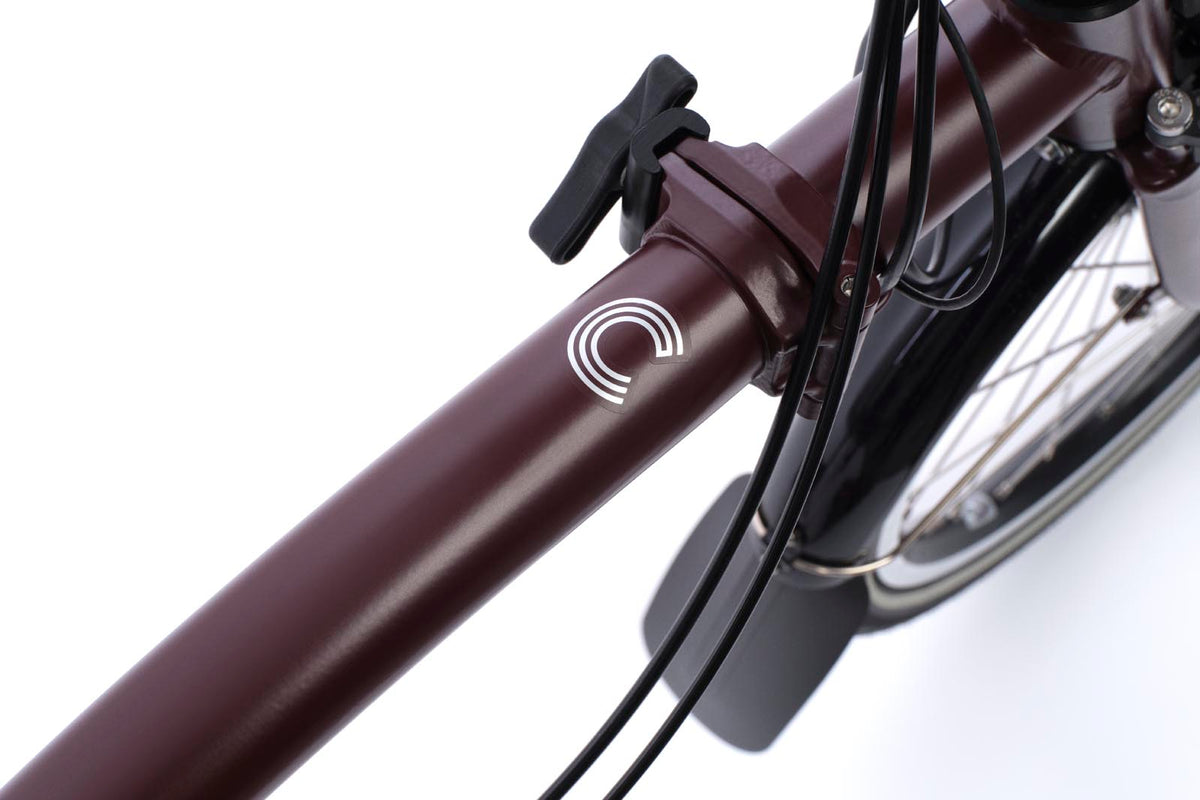 Brompton Electric C Line in plum red — frame detail with the Electric C badge