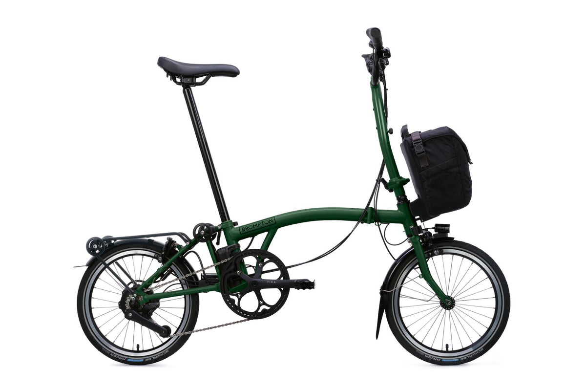 Brompton Electric C Line in racing green — full side view with front bag