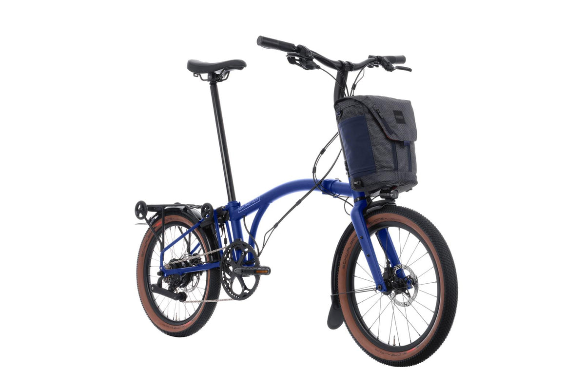 Brompton Electric G Line in Brompton blue — three-quarter view with front bag