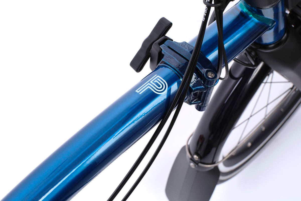 Brompton Electric P Line in pacific blue lacquer — frame detail with the Electric P badge