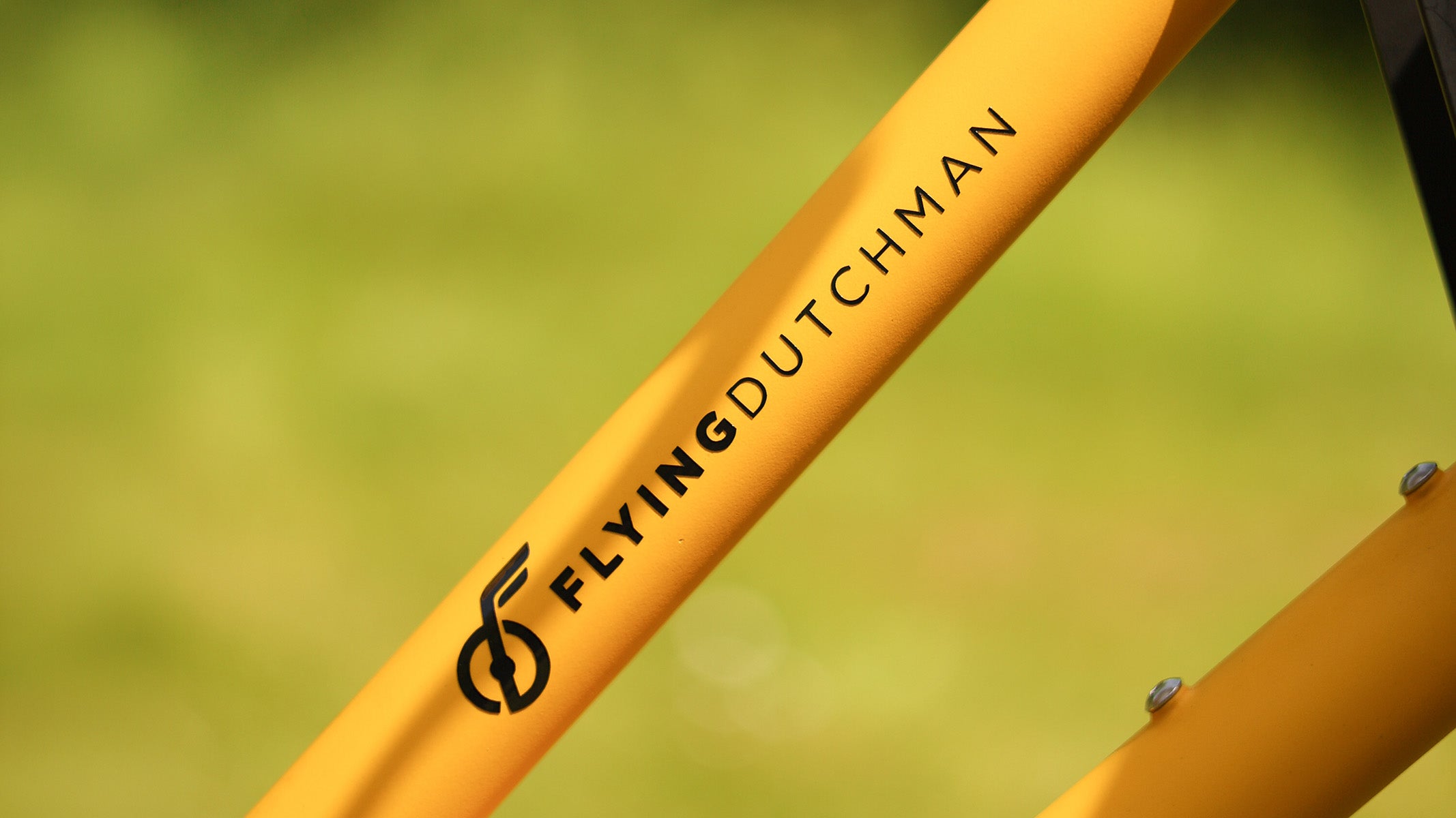 Close-up of the Flying Dutchman logo on a yellow bike frame