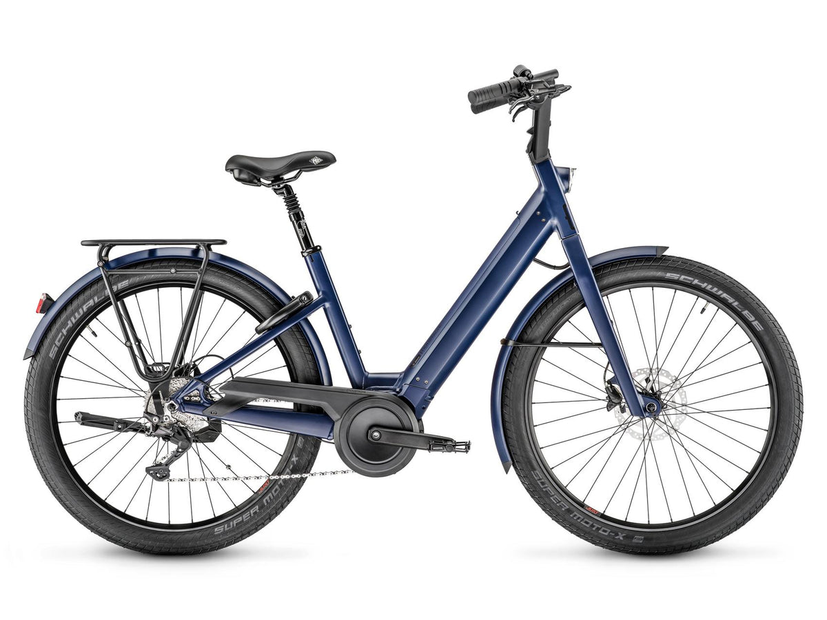 Moustache Lundi 27.3 in Midnight Blue, side view — low step-through frame with rear rack and integrated battery