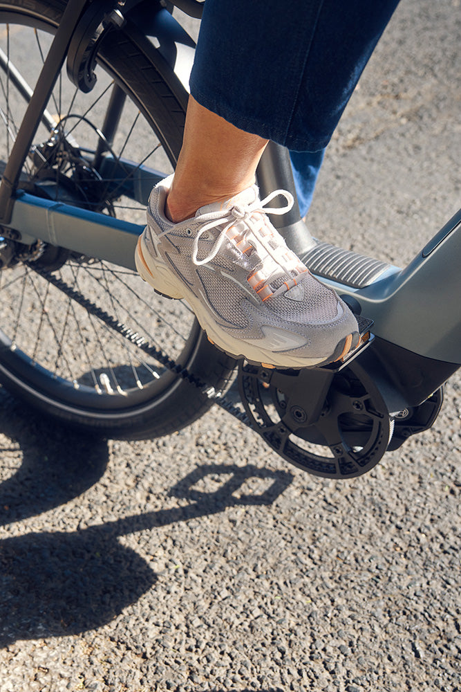 Rider setting off on a Nevo5 electric bike — foot on the pedal