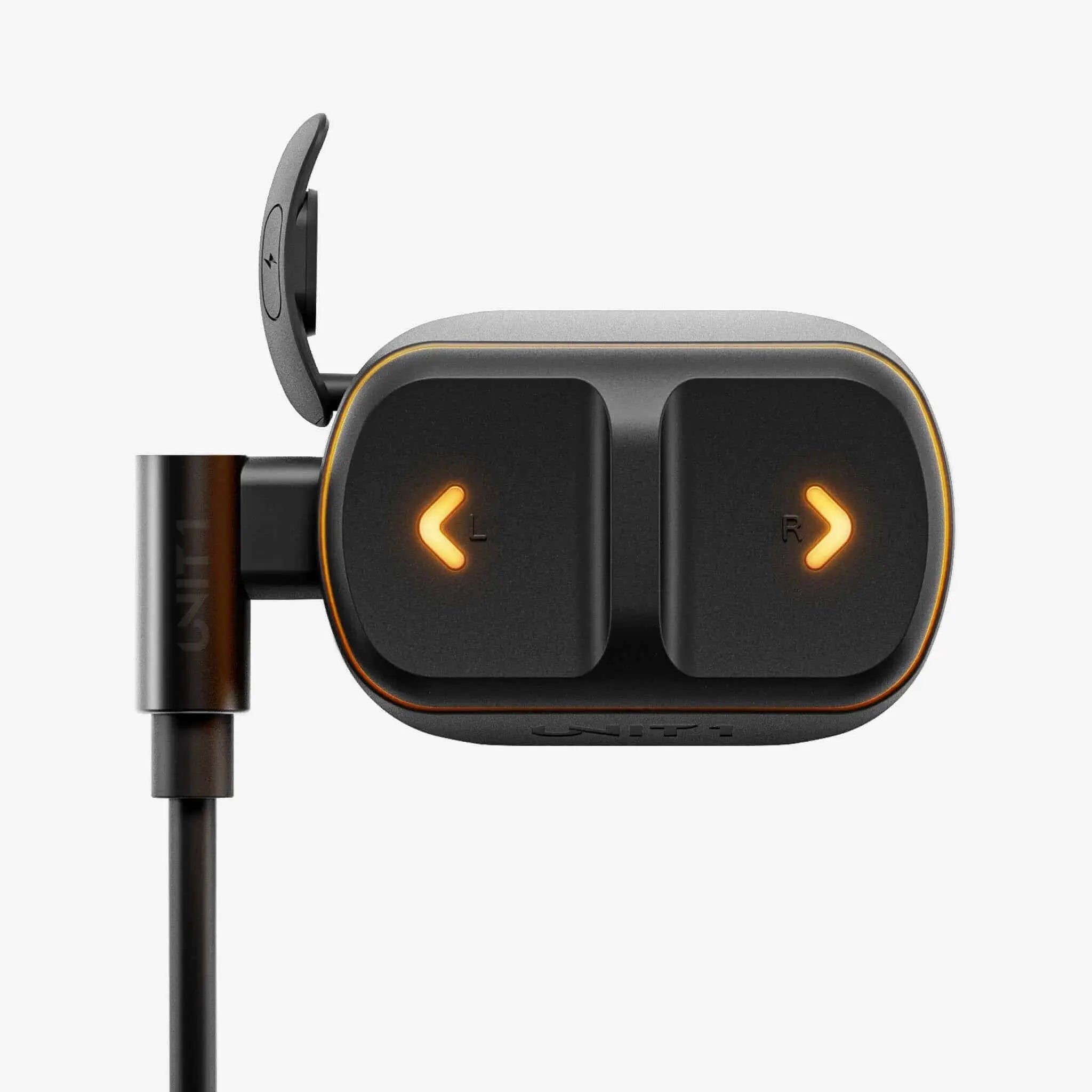 UNIT 1 Remote handlebar controller charging by USB-C, with the left and right turn-signal buttons lit amber